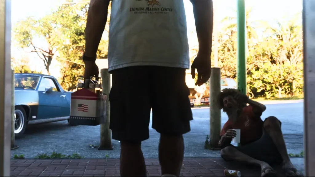 GTA 6 screenshot showing Jason with American flag cooler and female NPC at convenience store doorway