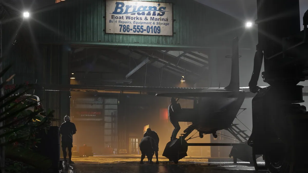 Seaplane inside Brian’s Boat Works hangar with shadowy figures in GTA 6 Trailer 2