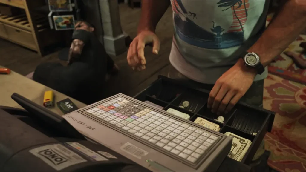 Jason robbing a store in GTA 6 Trailer 2, shown opening a cash register with a fallen clerk in the background.